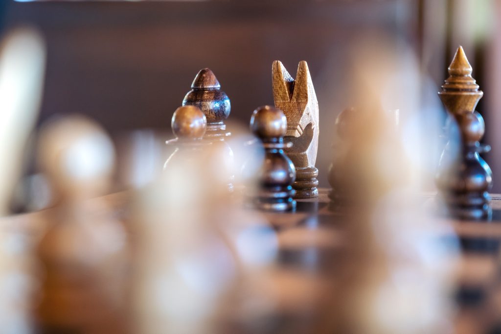 Closeup image of a wooden chess set on chessboard