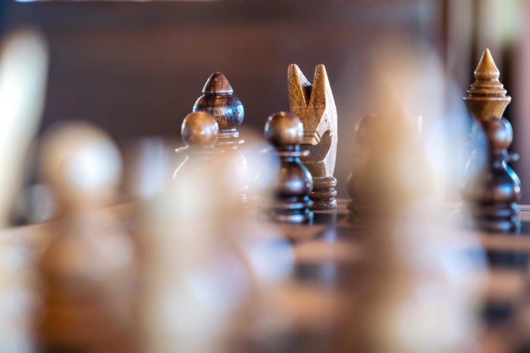 Closeup image of a wooden chess set on chessboard